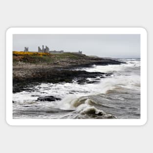 Dunstanburgh castle with rough waves battering the coast in Northumberland, UK Sticker